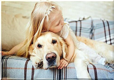 girl hugging her dog